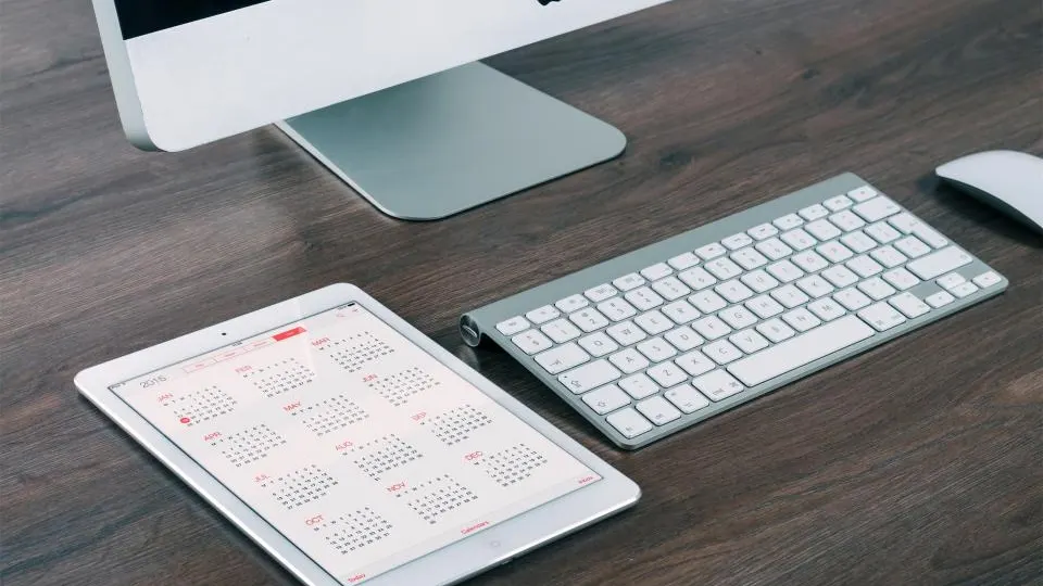Tablet showing a calendar next to a keyboard