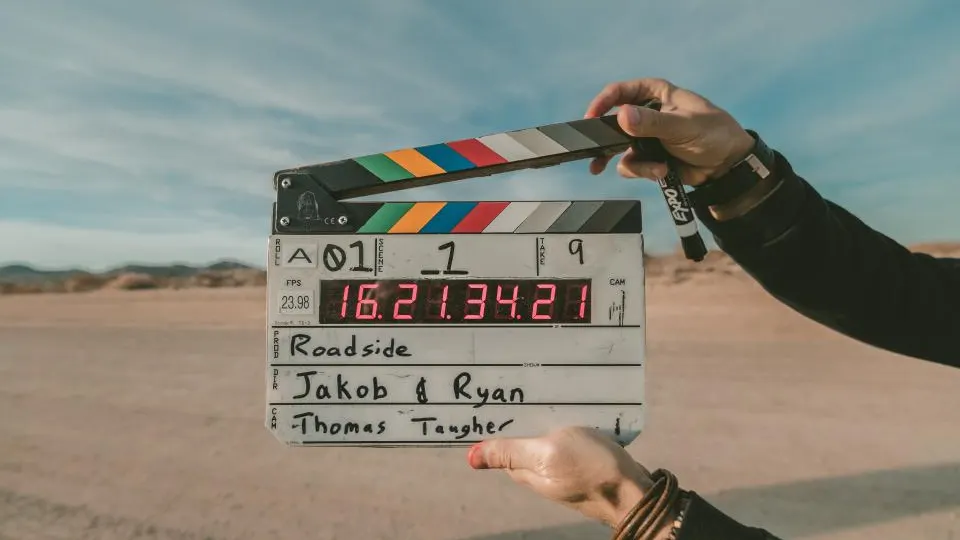 Clapperboard held up on a desert film set