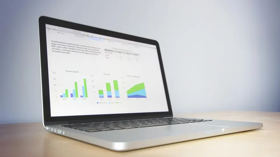 Laptop showing charts on a desk
